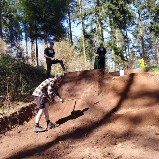 Volunteers digging a step-up jump at Cafeside